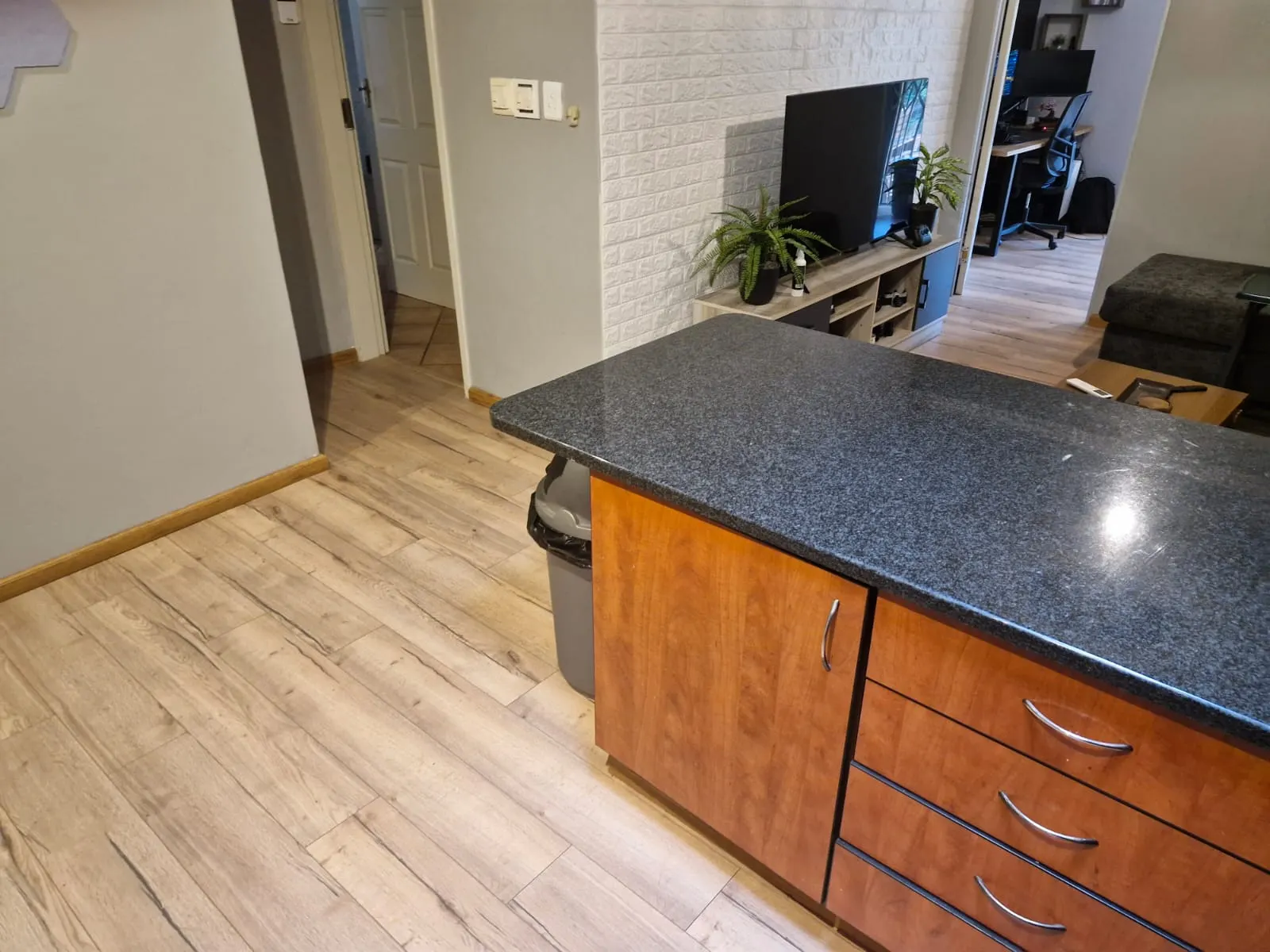 Granite kitchen counter with new laminate flooring